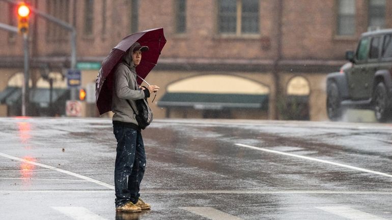 A man waits to cross Middle Neck Road in Great...