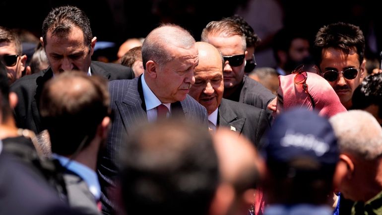 Turkish President Recep Tayyip Erdogan, center, and Cypriot leader Ersin...