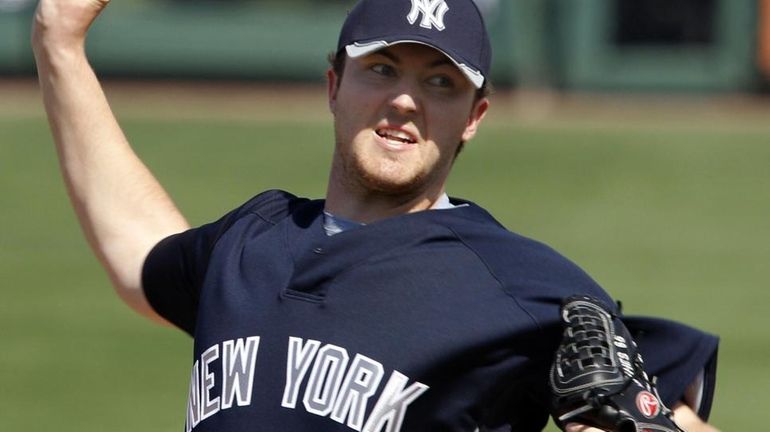 Phil Hughes throws against the Detroit Tigers during a spring...