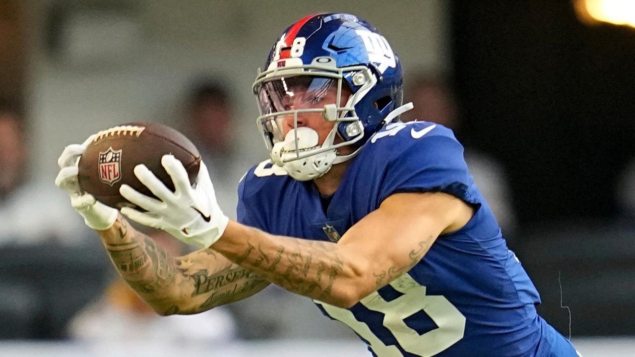 New York Giants wide receiver Isaiah Hodgins (18) runs with the ball  against the Washington Commanders during an NFL football game Sunday, Dec.  4, 2022, in East Rutherford, N.J. (AP Photo/Adam Hunger