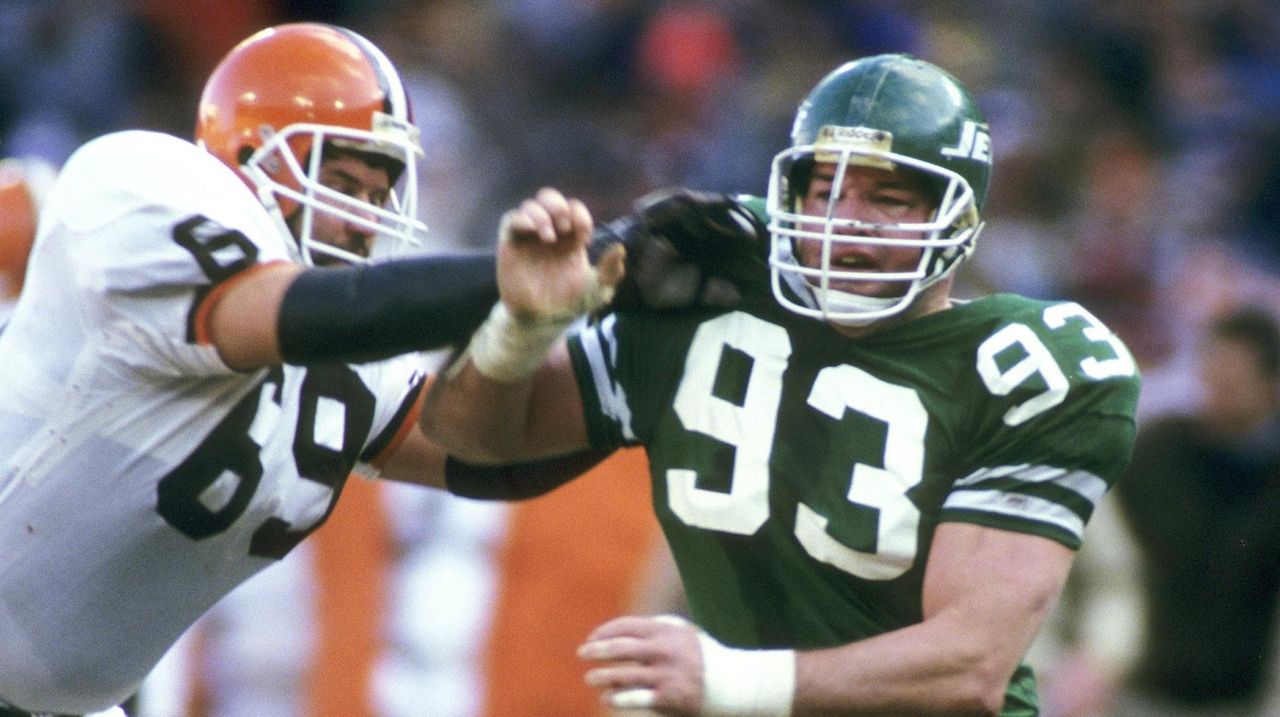 Defensive end Mark Gastineau of the New York Jets throws his hands in