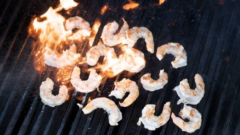 Shrimp are grilled over a high flame for a salad...