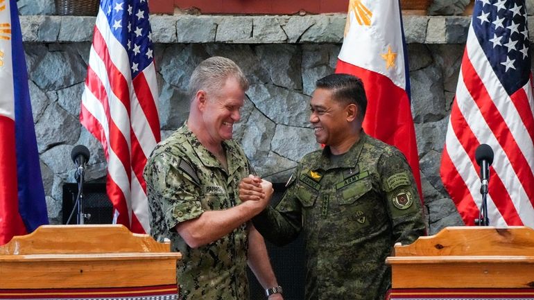 U.S. Indo-Pacific Command Commander Admiral Samuel Paparo, left, and Philippines...