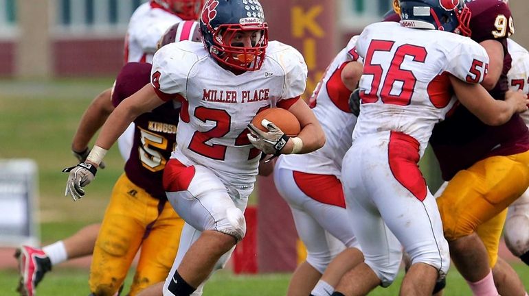 Miller Place's Brett Osman blows through the hole and picks...