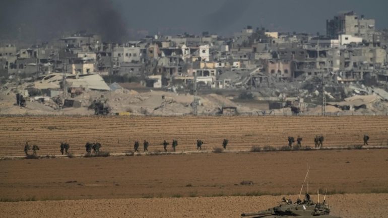 Israeli troops are seen near the Gaza Strip border, in...