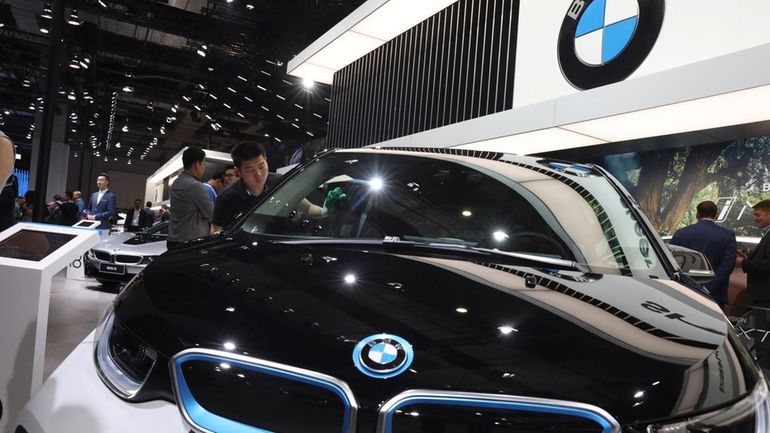 FILE -A worker cleans an electric vehicle at the BMW...