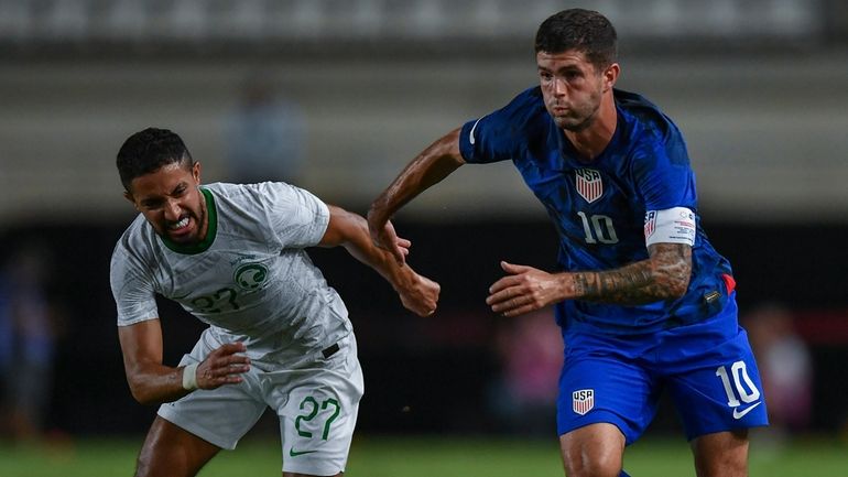 United States' Christian Pulisic, right, duels for the ball with...