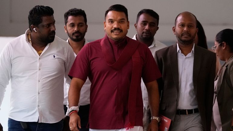 Presidential candidate Namal Rajapaksa arrives for a meeting along with...