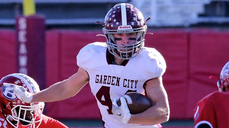 Garden City RB Robert Votruba takes the ball to the...