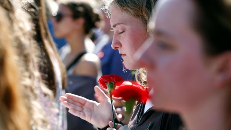 People gather to mourn the loss of Laken Riley during...