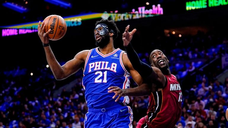 Philadelphia 76ers' Joel Embiid (21) and Miami Heat's Bam Adebayo...