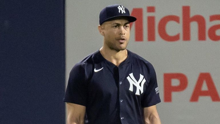 The Yankees’  Giancarlo Stanton stands in rightfield during a spring...