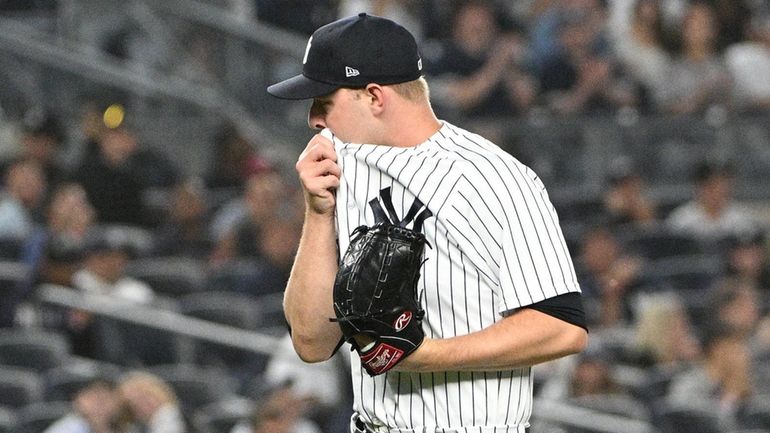 Yankees relief pitcher Michael King walks to the dugout after...