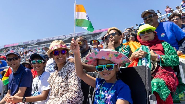 Team India fans cheer Saturday at the cricket grounds at...