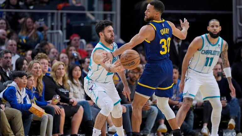 Charlotte Hornets guard Vasilije Micic, left, passes the ball while...