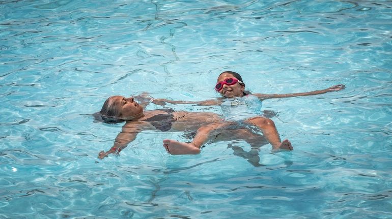 A woman and young girl cool off at the Jones...