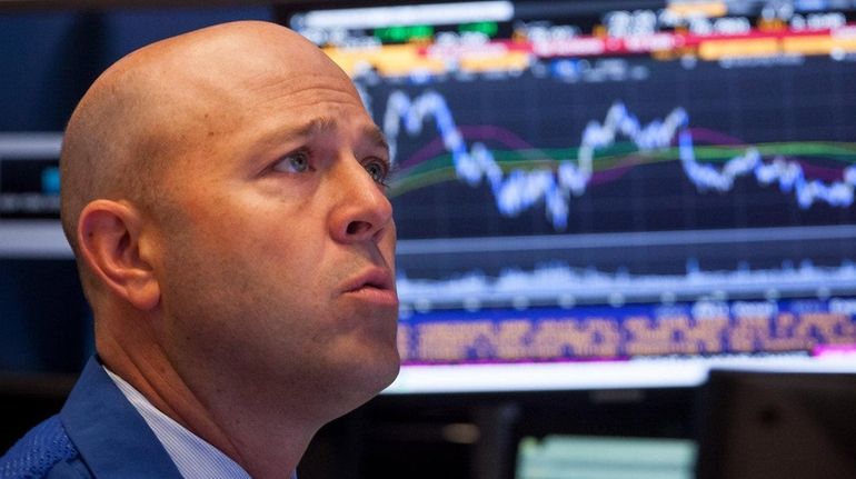 A trader works at the New York Stock Exchange on...