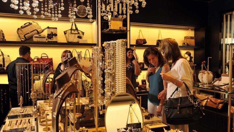 Shoppers browse merchandise in the newly opened Henri Bendel store...