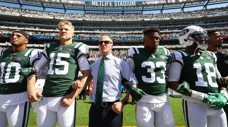 Jets chairman Christopher Johnson stands in unison with Josh McCown...