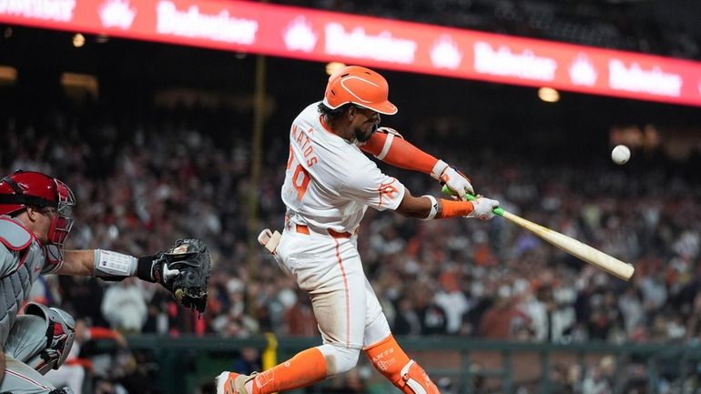 San Francisco Giants' Luis Matos hits a sacrifice fly against...