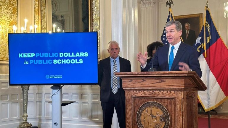 North Carolina Gov. Roy Cooper speaks at a news conference...