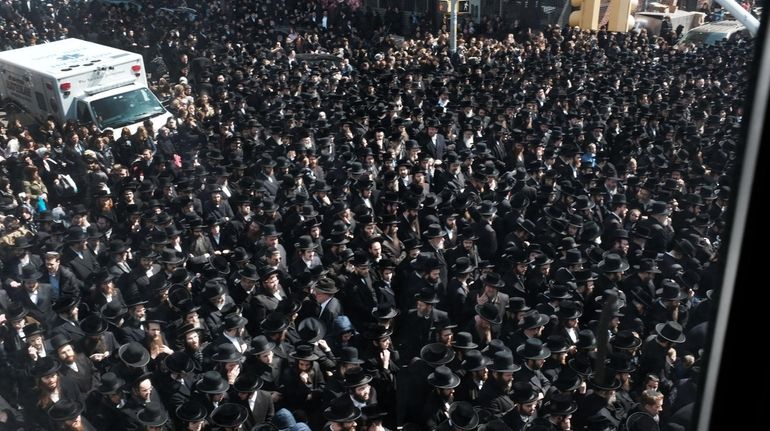 Thousands of mourners gather Tuesday in Borough Park, Brooklyn, for...