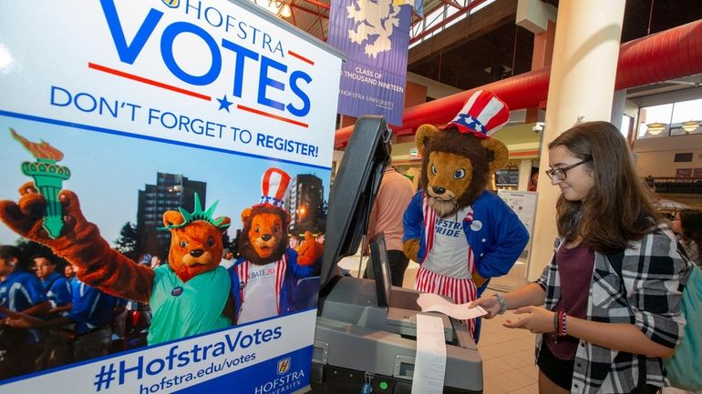 Hofstra mascot Willie Pride helps Katie Tierney with a demonstration at...