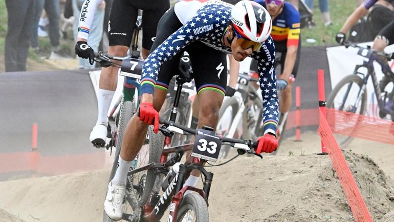 FILE -Christopher Blevins, of the United States, races in the...