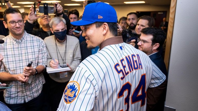 Mets pitcher Kodai Senga smiles at an introductory press conference...