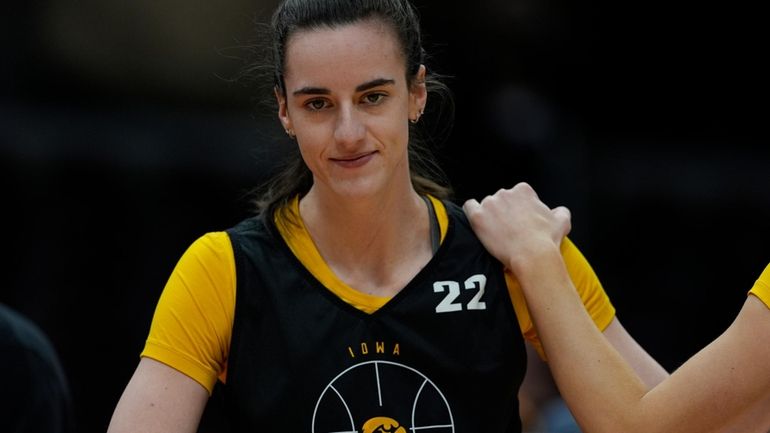 Iowa's Caitlin Clark smiles during a practice for an NCAA...