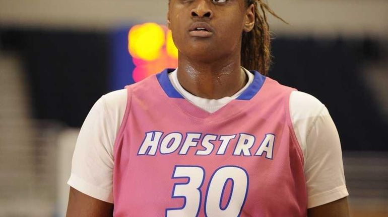 Hofstra forward Shante Evans checks the scoreboard during action against...