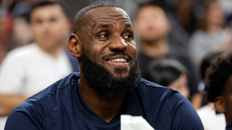 United States forward LeBron James watches play from the bench...