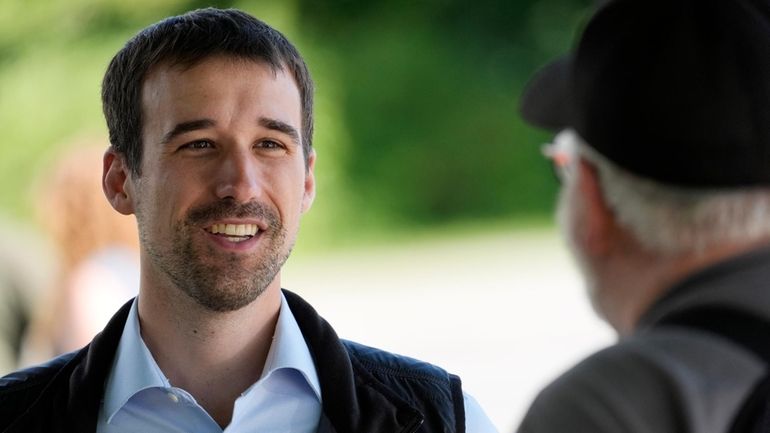 State Rep. Austin Theriault, R-Fort Kent, speaks with a voter,...