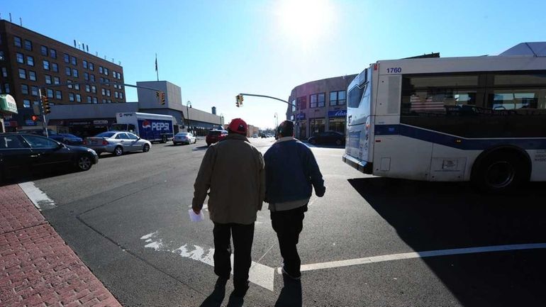 Pedestrians crossing at the intersection of Hempstead Turnpike and North...