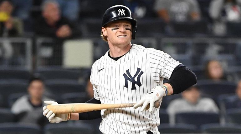 Yankees leftfielder Clint Frazier reacts after he struck out swinging...