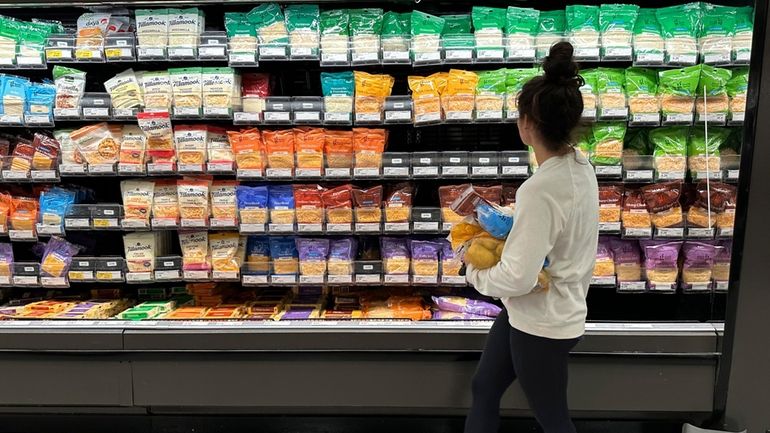 File - A shopper peruses cheese offerings at a Target...