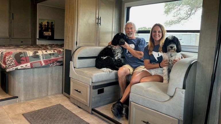 East Islip residents Eric and Eunice Lipsky with their dogs,...