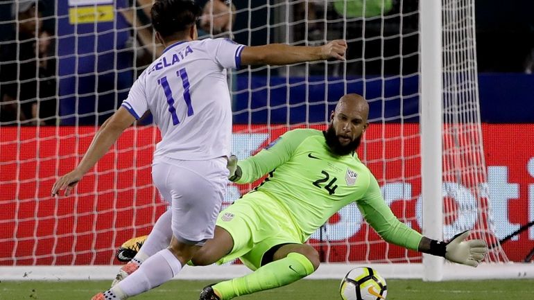 United States' goalie Tim Howard (24) blocks a shot by...