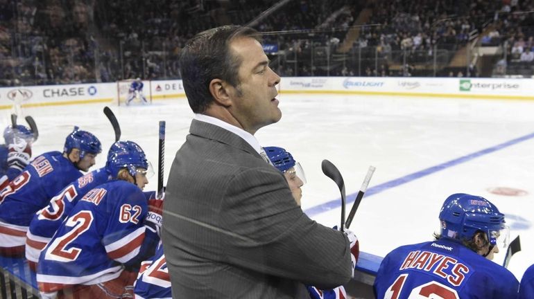 New York Rangers head coach Alain Vigneault looks on against...