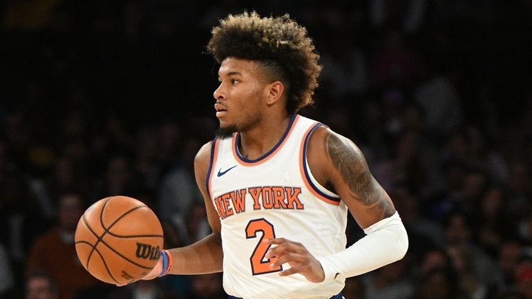 Knicks guard Miles McBride brings the ball upcourt against the...