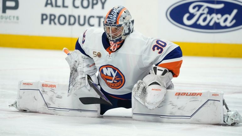 Islanders goaltender Ilya Sorokin stretches during a timeout in the...