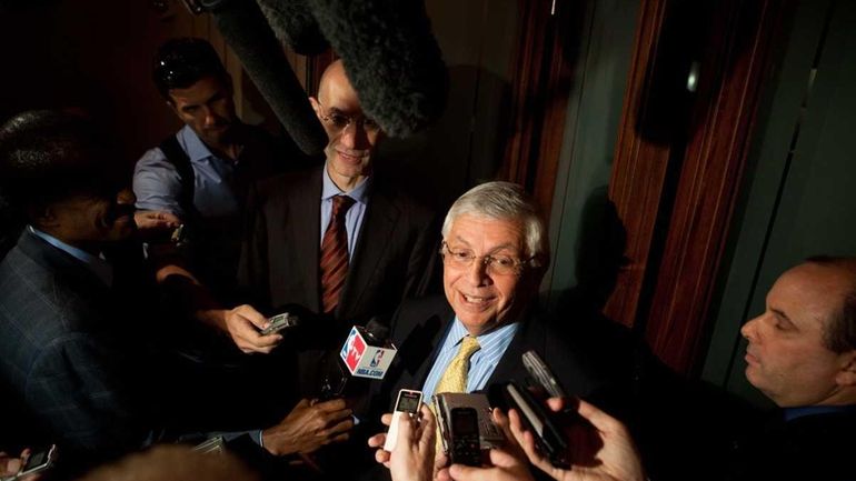 NBA Commissioner David Stern, center, speaks to reporters after a...