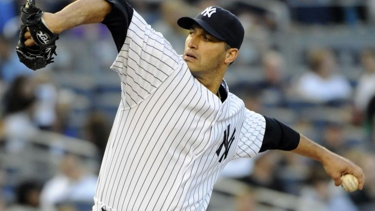 New York Yankees pitcher Andy Pettitte delivers the ball to...
