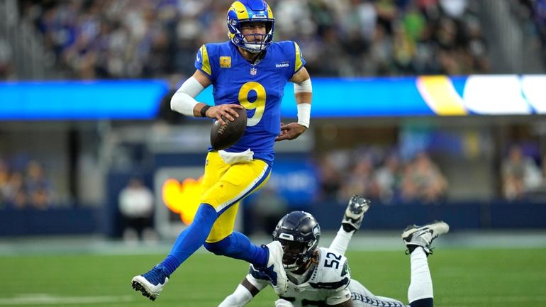 Los Angeles Rams quarterback Matthew Stafford (9) runs the ball...