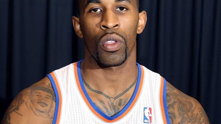 Chris Smith poses with a basketball at Knicks media day....