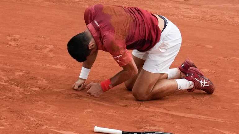 Serbia's Novak Djokovic slipped and fell during the fourth round...