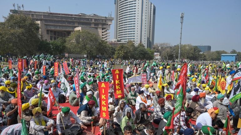 Indian farmers who have been protesting to demand guaranteed crop...