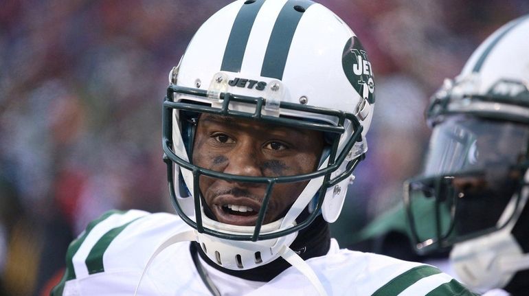 Jets wide receiver Brandon Marshall looks on from the sideline...