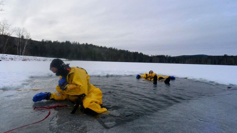 Members of the Bellows Falls, Vt., Fire Department practice cold...