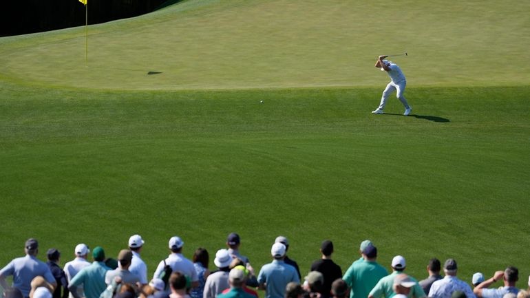 Tyrrell Hatton, of England, reacts on the 11th hole during...